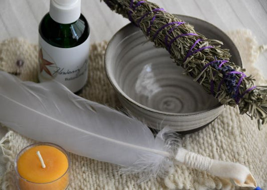 Smudge ritual kit with sage, feather, candle, bowl and balancing spray