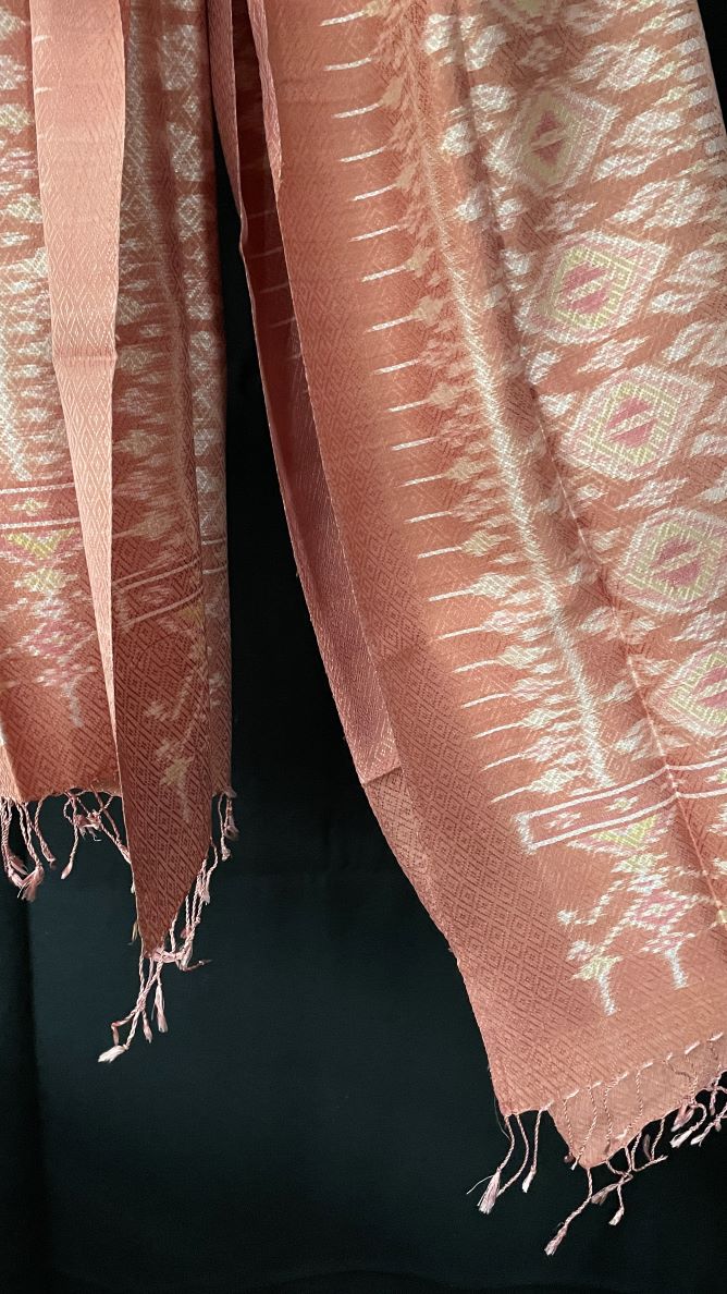 From Surin province in Thailand, this luxurious shawl is 100% handwoven silk.  The dyes are natural from leaves, bark and flowers, creating color that is rich but subtle: rose, pink, hints of green and ivory