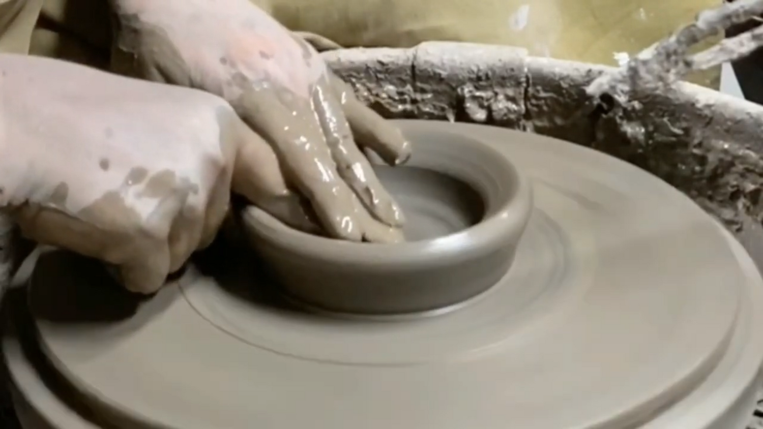 Rebecca of Gravesco Pottery throwing pottery on the wheel (close up of her hands working) and a voice over by Deb Swingholm of Flowering Moon describing the process of making ritual items.