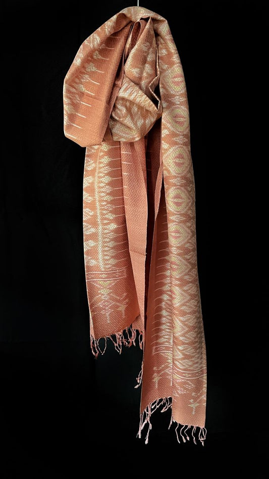 From Surin province in Thailand, this luxurious shawl is 100% handwoven silk. The dyes are natural from leaves, bark and flowers, creating color that is rich but subtle: rose, pink, hints of green and ivory