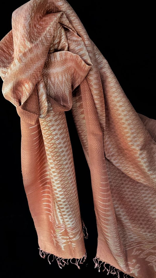 From Surin province in Thailand, this luxurious shawl is 100% handwoven silk. The dyes are natural from leaves, bark and flowers, creating color that is rich but subtle: rose, pink, hints of green and ivory.