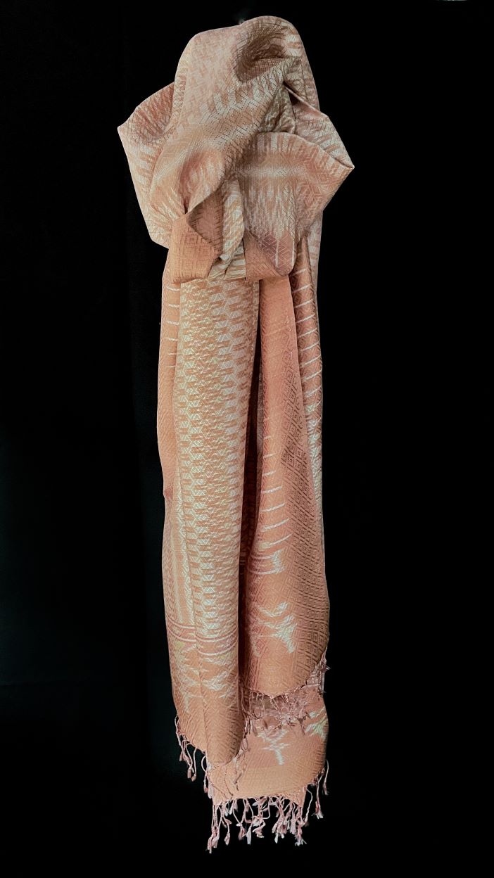 From Surin province in Thailand, this luxurious shawl is 100% handwoven silk.  The dyes are natural from leaves, bark and flowers, creating color that is rich but subtle: rose, pink, hints of green and ivory. 
